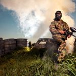 A man with paintball gear defending his hill.
